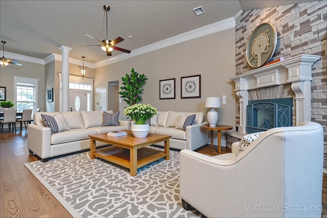 6708 Austin Harbor Loop, Sherwood, AR 72120 - living area with a ceiling fan, wood finished floors, a fireplace with raised hearth, and ornamental molding