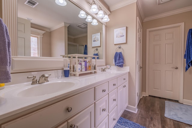 6708 Austin Harbor Loop, Sherwood, AR 72120 - bathroom featuring double vanity, wood finished floors, ornamental molding, and a shower with shower door