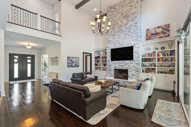 18001 Oak Creek Pl, Little Rock, AR 72223 - living room with a towering ceiling, dark wood-style flooring, a fireplace, and a chandelier