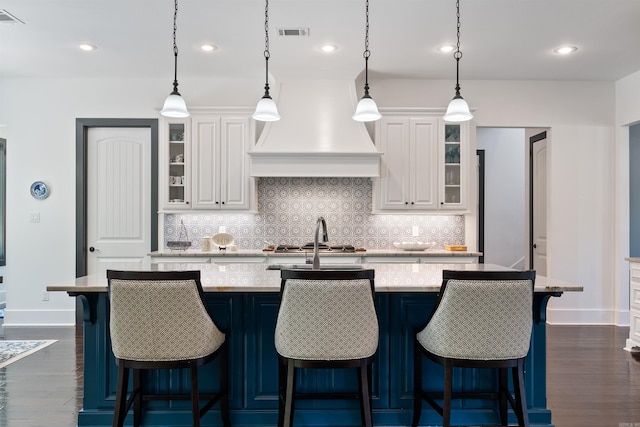 18001 Oak Creek Pl, Little Rock, AR 72223 - kitchen with custom range hood, decorative backsplash, white cabinetry, dark wood-style floors, and recessed lighting