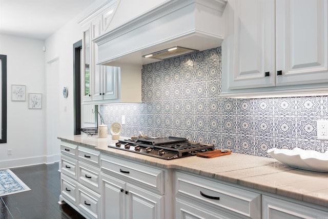 18001 Oak Creek Pl, Little Rock, AR 72223 - kitchen featuring stainless steel gas stovetop, custom exhaust hood, tasteful backsplash, white cabinetry, and light countertops