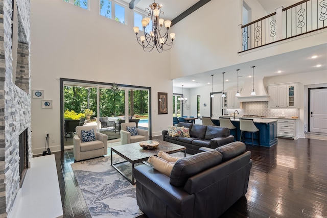 18001 Oak Creek Pl, Little Rock, AR 72223 - living area featuring a high ceiling, a chandelier, dark wood-style floors, and a fireplace