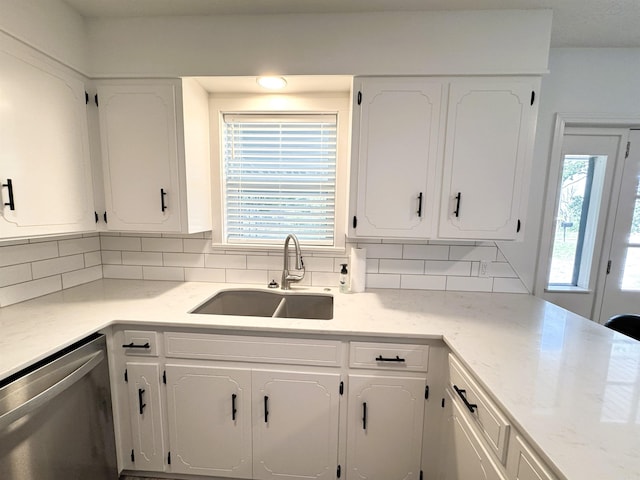 kitchen with stainless steel dishwasher and white cabinets