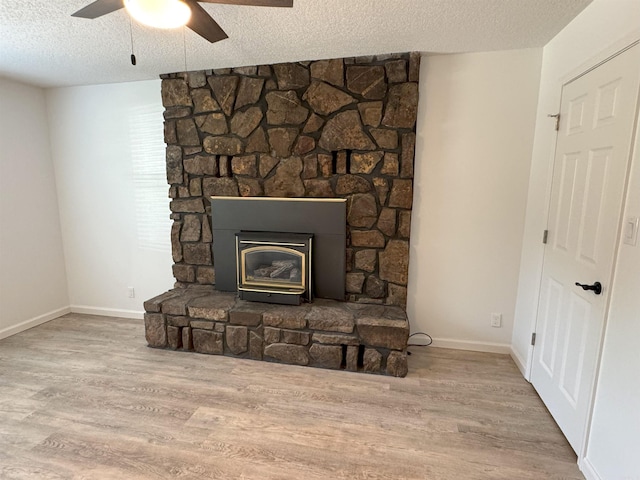 detailed view of a textured ceiling, wood finished floors, and ceiling fan