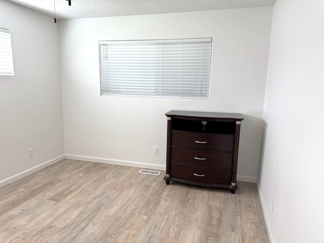 unfurnished bedroom featuring light wood-style floors