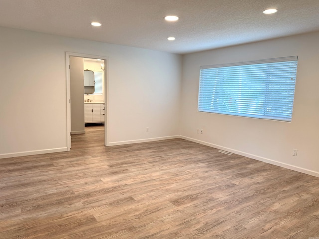 unfurnished room featuring wood finished floors and recessed lighting