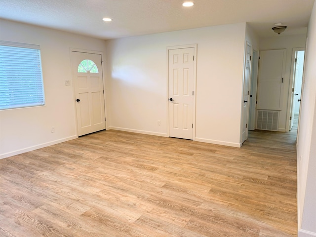 foyer featuring light wood-type flooring and recessed lighting