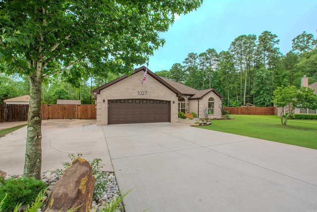 1027 Evening Sunset Cir, Redfield, AR 72132 - view of front facade with concrete driveway, a garage, and brick siding