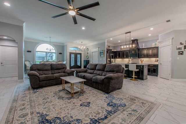 1027 Evening Sunset Cir, Redfield, AR 72132 - living area featuring a chandelier, crown molding, recessed lighting, ceiling fan, and light marble finish floors