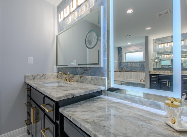 1027 Evening Sunset Cir, Redfield, AR 72132 - bathroom with two vanities, a bath, and recessed lighting