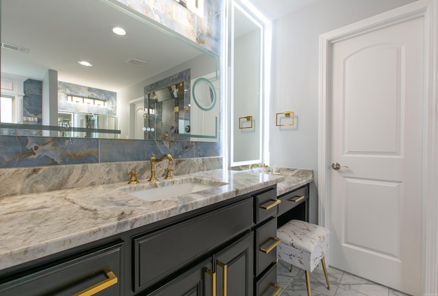 1027 Evening Sunset Cir, Redfield, AR 72132 - bathroom with vanity, marble finish flooring, and recessed lighting