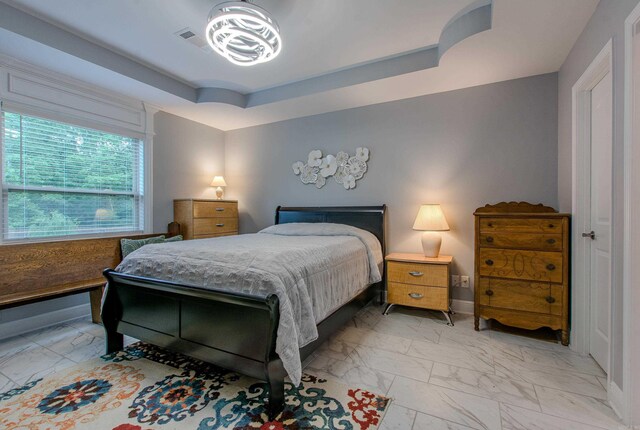 1027 Evening Sunset Cir, Redfield, AR 72132 - bedroom featuring light marble finish flooring and a raised ceiling