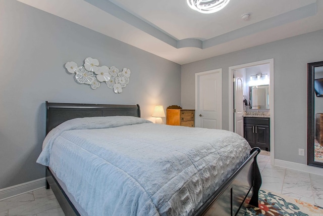 1027 Evening Sunset Cir, Redfield, AR 72132 - bedroom with light marble finish flooring, a raised ceiling, and ensuite bath