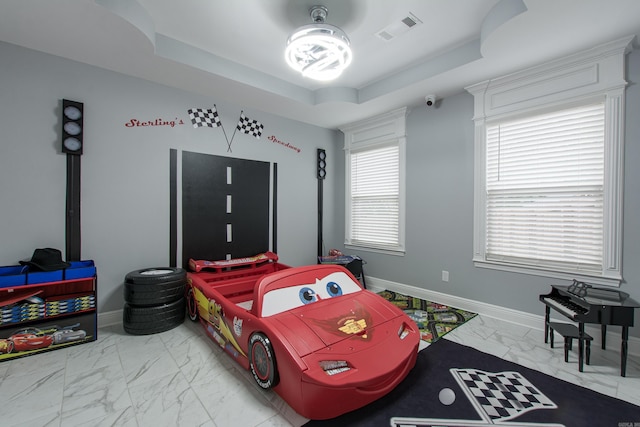1027 Evening Sunset Cir, Redfield, AR 72132 - bedroom featuring marble look tiles and a tray ceiling