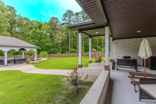1027 Evening Sunset Cir, Redfield, AR 72132 - fenced backyard featuring a patio, an outdoor hangout area, and a playground