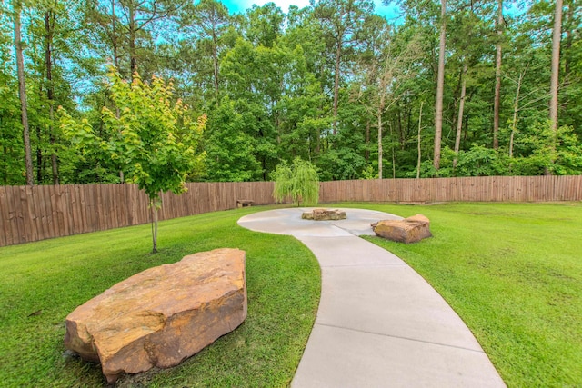 1027 Evening Sunset Cir, Redfield, AR 72132 - fenced backyard featuring a fire pit