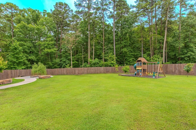1027 Evening Sunset Cir, Redfield, AR 72132 - fenced backyard featuring a playground