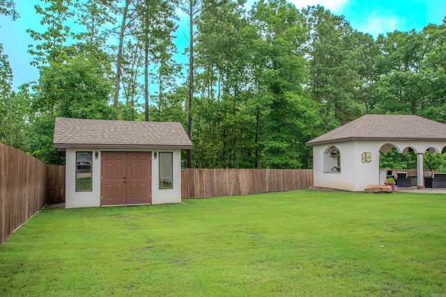 1027 Evening Sunset Cir, Redfield, AR 72132 - fenced backyard featuring an outbuilding