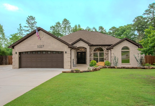 1027 Evening Sunset Cir, Redfield, AR 72132 - french provincial home featuring an attached garage, brick siding, driveway, and a shingled roof