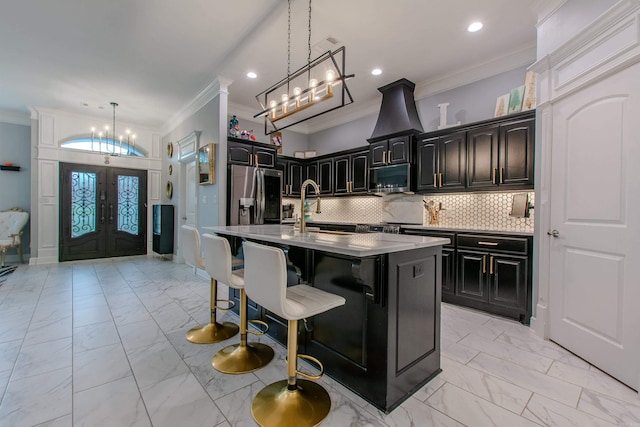 1027 Evening Sunset Cir, Redfield, AR 72132 - kitchen with light marble finish flooring, stainless steel appliances, crown molding, french doors, and a chandelier