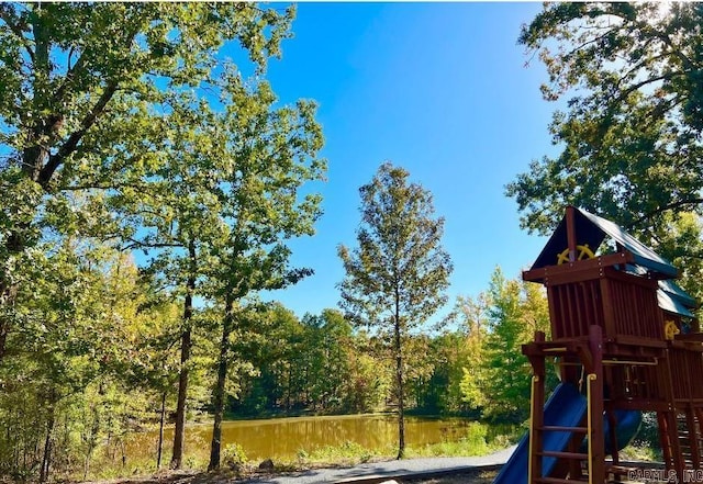 14408 Stonebrook Ln, Maumelle, AR 72113 - community jungle gym featuring a wooded view