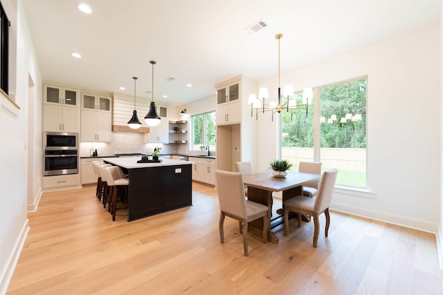 14408 Stonebrook Ln, Maumelle, AR 72113 - dining area with light wood-style flooring, a chandelier, and recessed lighting