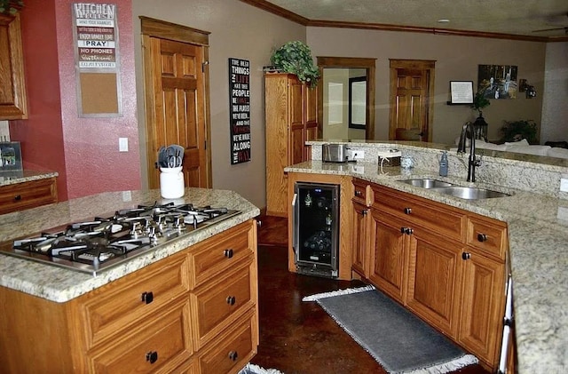 847 Woodland Hills Dr, Mountain View, AR 72560 - kitchen with wine cooler, stainless steel gas cooktop, crown molding, brown cabinets, and light stone countertops