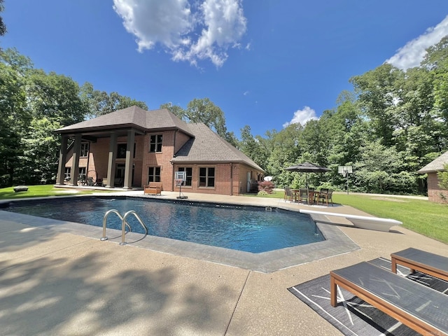 847 Woodland Hills Dr, Mountain View, AR 72560 - swimming pool with a patio area, a diving board, a lawn, and outdoor dining space