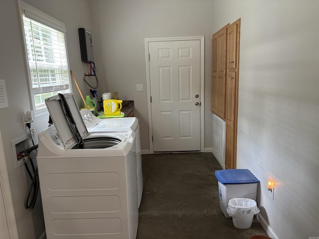 washroom featuring washing machine and dryer and baseboards