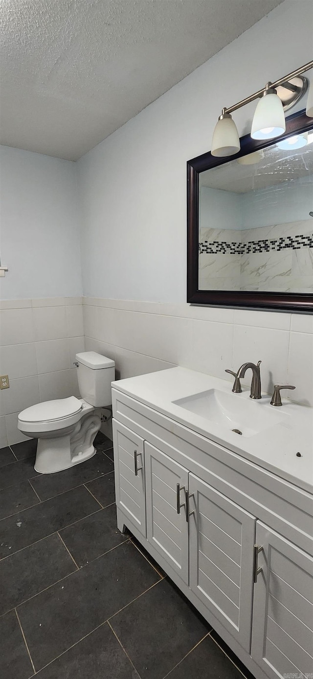 600 Robin Rd, White Hall, AR 71602 - bathroom featuring tile walls, vanity, tile patterned flooring, a textured ceiling, and wainscoting