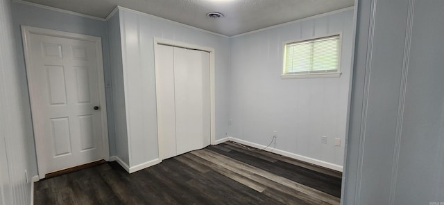 600 Robin Rd, White Hall, AR 71602 - unfurnished bedroom featuring ornamental molding, dark wood-style floors, and a closet