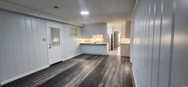 600 Robin Rd, White Hall, AR 71602 - kitchen featuring dark wood finished floors, freestanding refrigerator, light countertops, and a peninsula