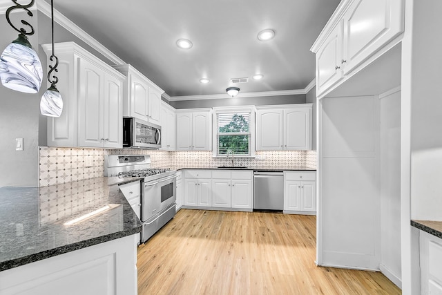 706 Greystone Blvd, Cabot, AR 72023 - kitchen featuring stainless steel appliances, light wood-style flooring, white cabinetry, ornamental molding, and decorative backsplash