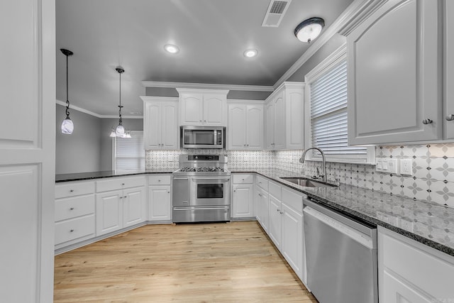 706 Greystone Blvd, Cabot, AR 72023 - kitchen featuring stainless steel appliances, crown molding, white cabinets, backsplash, and dark stone countertops