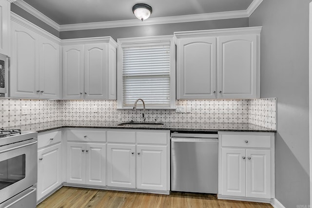 706 Greystone Blvd, Cabot, AR 72023 - kitchen with stainless steel appliances, dark stone countertops, white cabinets, light wood-type flooring, and crown molding