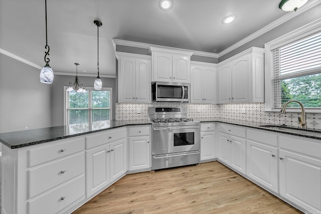 706 Greystone Blvd, Cabot, AR 72023 - kitchen featuring appliances with stainless steel finishes, ornamental molding, a peninsula, dark stone counters, and white cabinets