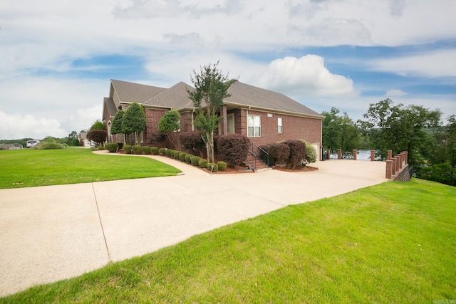 706 Greystone Blvd, Cabot, AR 72023 - view of front facade with brick siding, a front yard, an outdoor structure, and driveway
