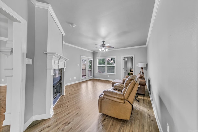 706 Greystone Blvd, Cabot, AR 72023 - living area featuring a fireplace, ceiling fan, wood finished floors, and ornamental molding