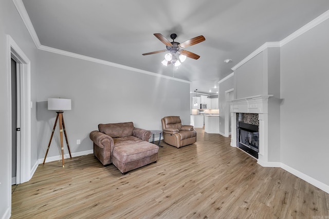 706 Greystone Blvd, Cabot, AR 72023 - living area featuring ceiling fan, ornamental molding, light wood-style flooring, and a tiled fireplace