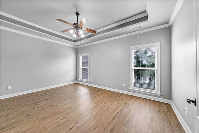 706 Greystone Blvd, Cabot, AR 72023 - spare room featuring a tray ceiling, ceiling fan, light wood-style flooring, and crown molding
