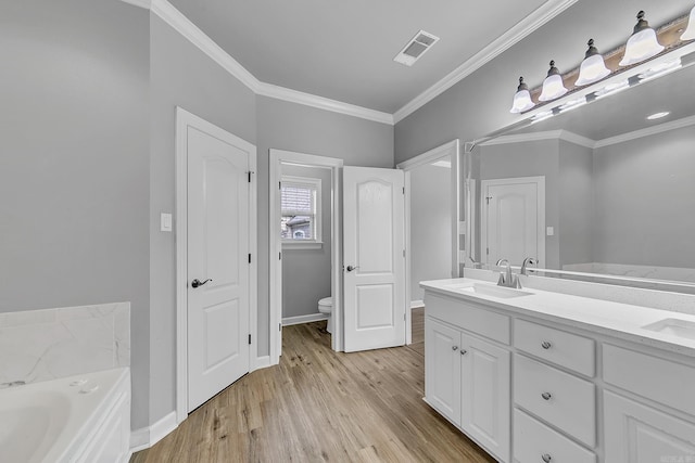 706 Greystone Blvd, Cabot, AR 72023 - full bath with double vanity, a garden tub, wood finished floors, and crown molding