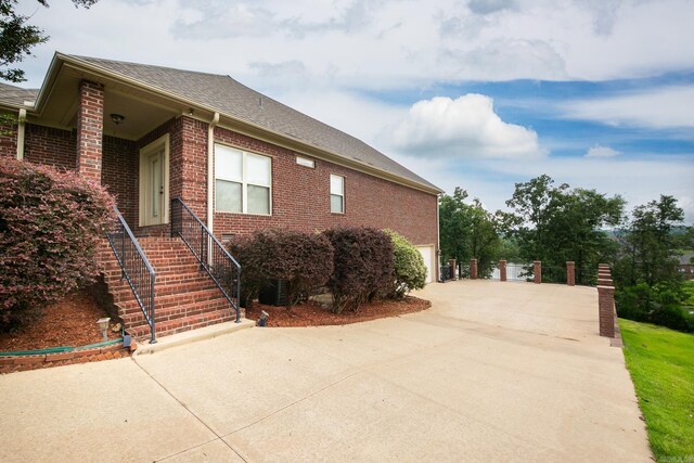 706 Greystone Blvd, Cabot, AR 72023 - view of front facade featuring concrete driveway, brick siding, a garage, and a shingled roof