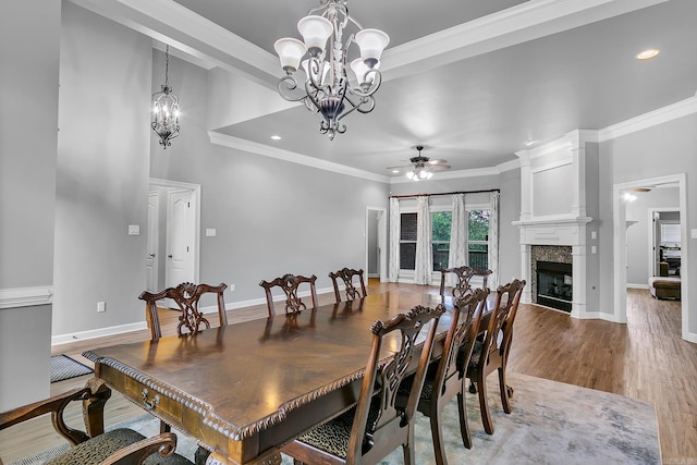 706 Greystone Blvd, Cabot, AR 72023 - dining room featuring ceiling fan, a fireplace, crown molding, a chandelier, and wood finished floors