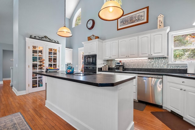 175 Appaloosa Trl, Hot Springs, AR 71909 - kitchen featuring black appliances, high vaulted ceiling, dark countertops, white cabinetry, and tasteful backsplash