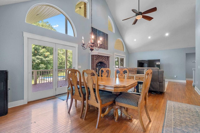 175 Appaloosa Trl, Hot Springs, AR 71909 - dining space featuring high vaulted ceiling, wood-type flooring, a ceiling fan, a brick fireplace, and a chandelier