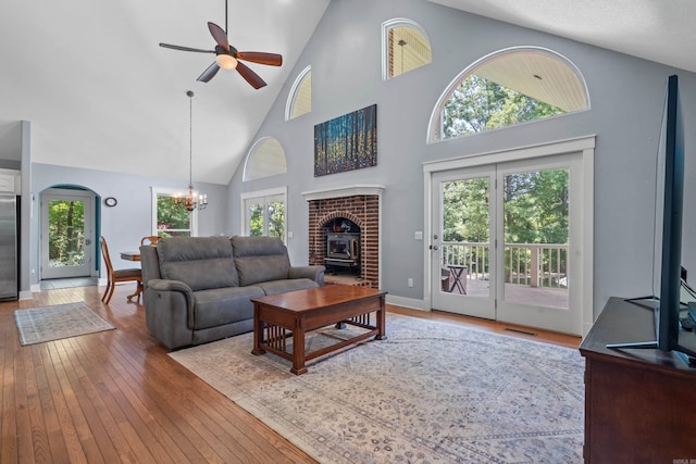175 Appaloosa Trl, Hot Springs, AR 71909 - living area with a wood stove, high vaulted ceiling, a chandelier, ceiling fan, and hardwood / wood-style flooring