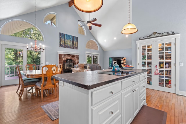 175 Appaloosa Trl, Hot Springs, AR 71909 - kitchen with dark countertops, high vaulted ceiling, light wood-style flooring, black electric cooktop, and a chandelier