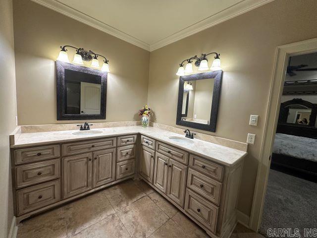14 Longwell Loop, Little Rock, AR 72211 - full bathroom featuring double vanity, ensuite bathroom, crown molding, and tile patterned flooring