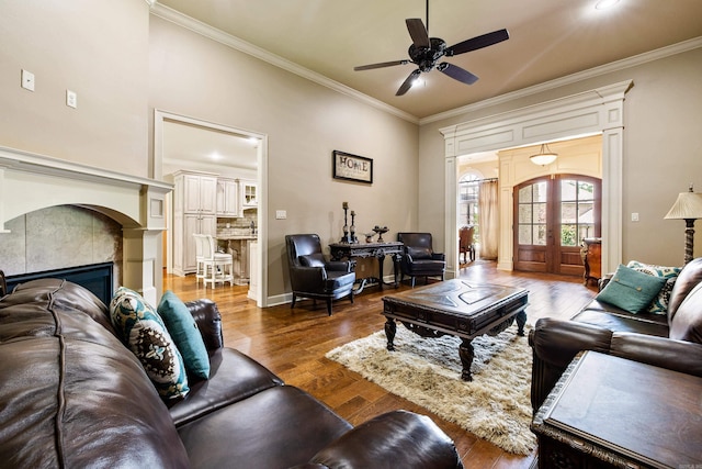 14 Longwell Loop, Little Rock, AR 72211 - living area with crown molding, a ceiling fan, wood finished floors, a tile fireplace, and french doors