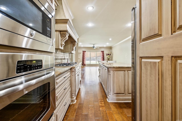 14 Longwell Loop, Little Rock, AR 72211 - kitchen with stainless steel appliances, crown molding, dark wood-style flooring, a ceiling fan, and light stone countertops